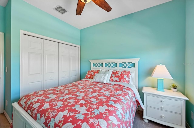 bedroom featuring a closet, ceiling fan, and dark colored carpet