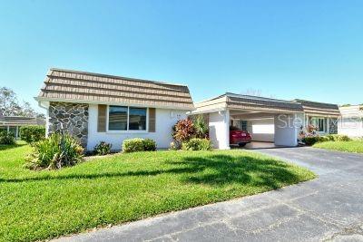 ranch-style home with a front lawn and a garage