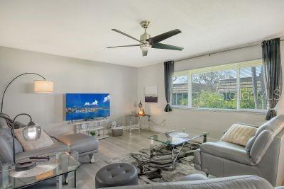 living room with hardwood / wood-style floors and ceiling fan