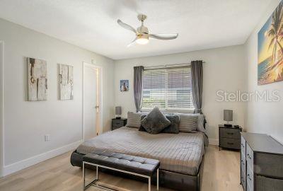 bedroom featuring light wood-type flooring and ceiling fan