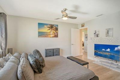 bedroom with light hardwood / wood-style floors and ceiling fan