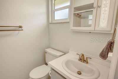 bathroom featuring vanity, toilet, and walk in shower