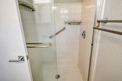 bathroom featuring a shower with door