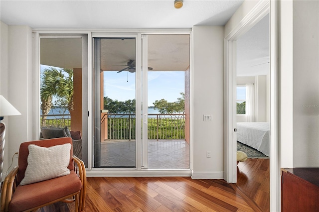 doorway to outside with hardwood / wood-style flooring, a healthy amount of sunlight, and ceiling fan