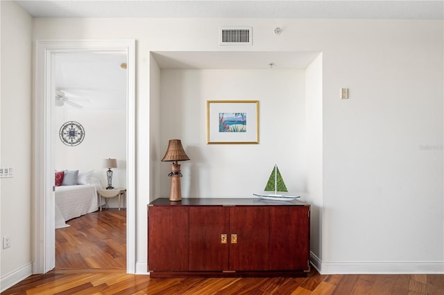 corridor with hardwood / wood-style floors