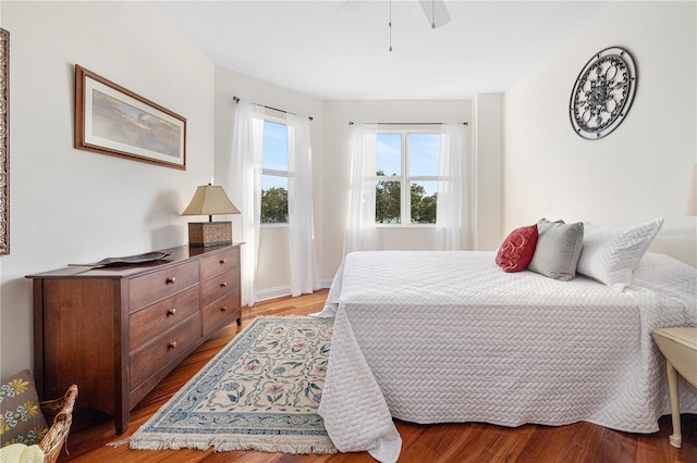 bedroom with light hardwood / wood-style flooring and ceiling fan