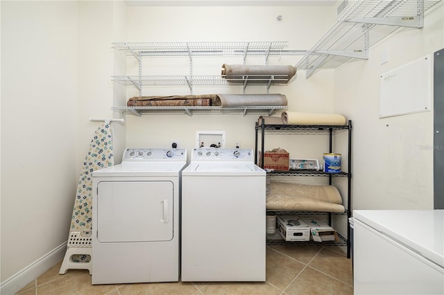 washroom with washer and dryer and light tile patterned floors