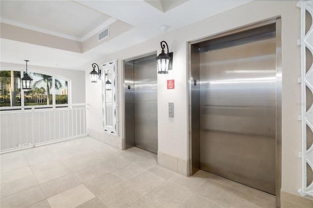 hall with crown molding, light tile patterned flooring, and elevator