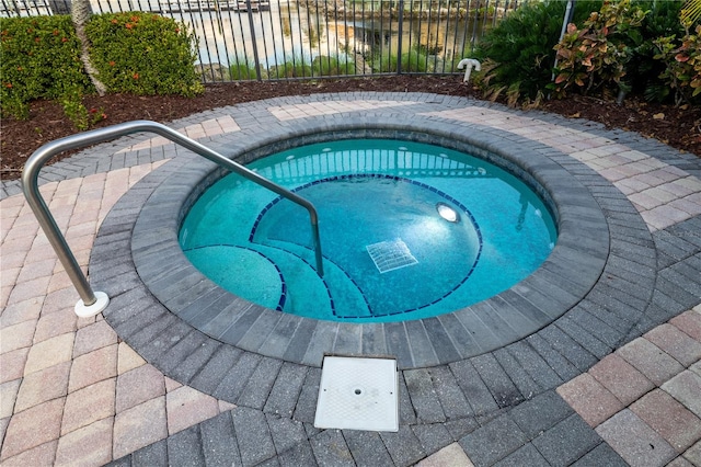 view of swimming pool with an in ground hot tub