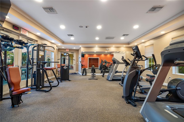 exercise room featuring ornamental molding and carpet