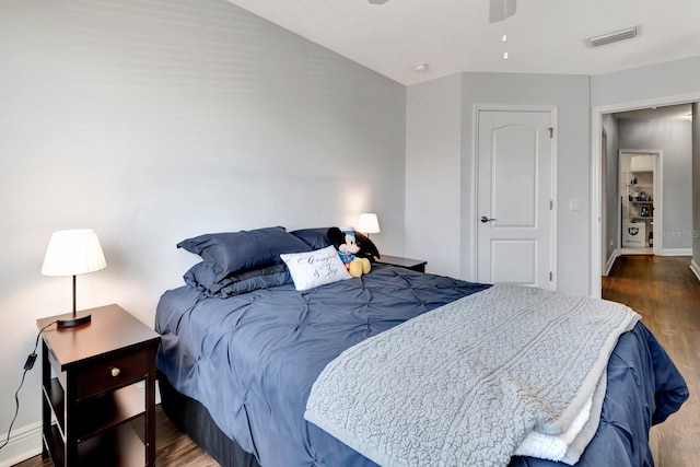 bedroom with dark wood-type flooring and ceiling fan