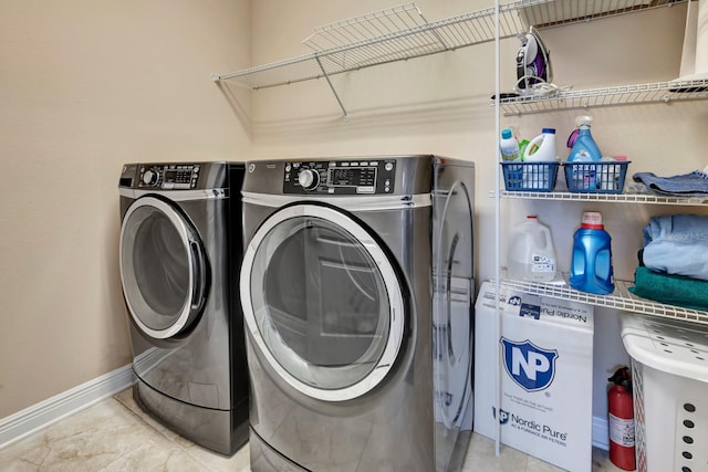 laundry room featuring light tile patterned flooring and separate washer and dryer