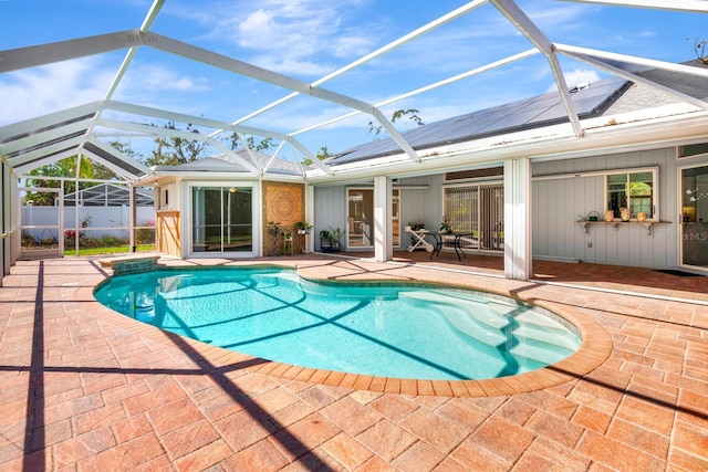 view of swimming pool with a lanai and a patio