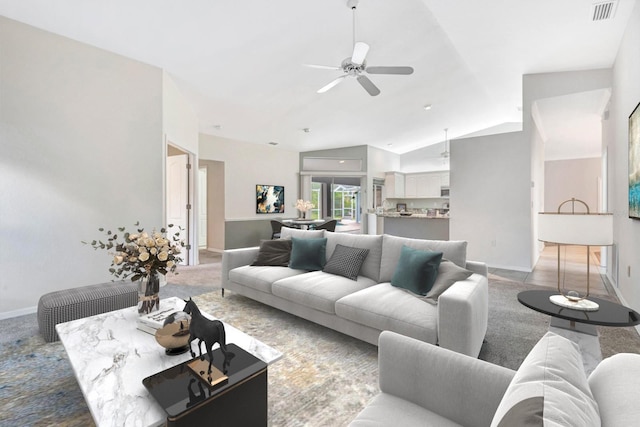 carpeted living room featuring ceiling fan and lofted ceiling