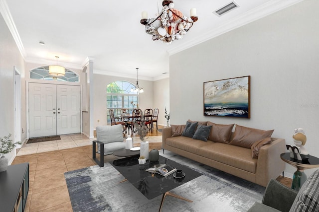 tiled living room with crown molding and an inviting chandelier