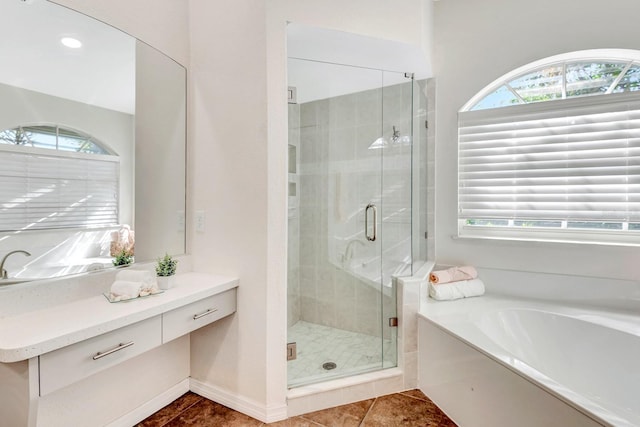 bathroom with tile patterned floors, vanity, and independent shower and bath