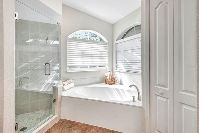 bathroom with tile patterned floors and shower with separate bathtub