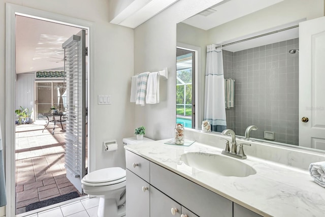 bathroom with a shower with curtain, toilet, tile patterned floors, and vanity