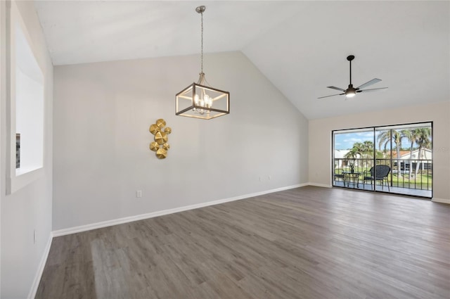 unfurnished living room with dark wood-type flooring, high vaulted ceiling, and ceiling fan with notable chandelier