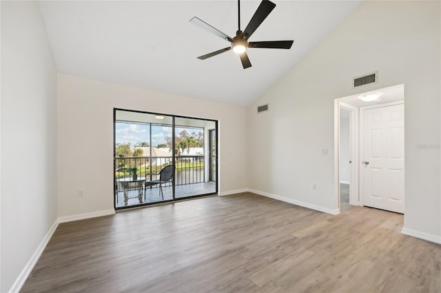 empty room featuring high vaulted ceiling, light wood-type flooring, and ceiling fan