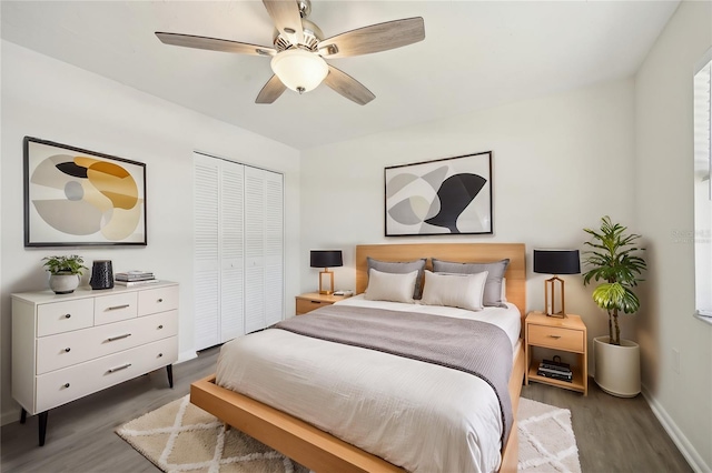 bedroom featuring a closet, ceiling fan, and dark hardwood / wood-style flooring