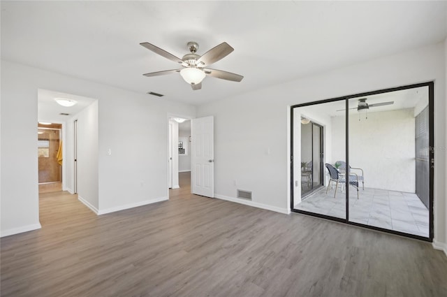 unfurnished room with hardwood / wood-style floors and ceiling fan