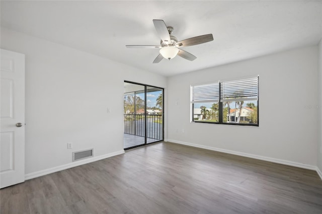 unfurnished room featuring ceiling fan and dark hardwood / wood-style flooring