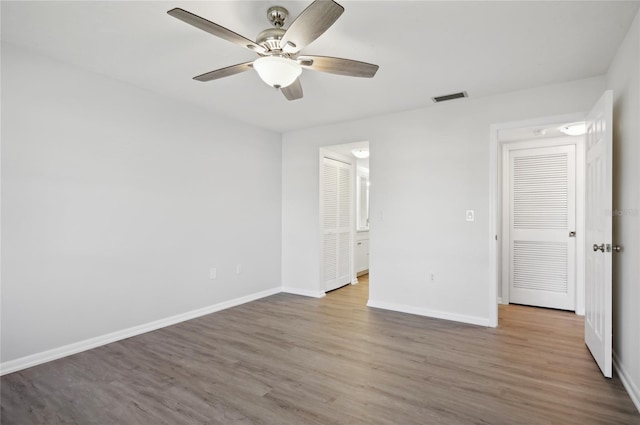 unfurnished bedroom featuring a closet, ceiling fan, and hardwood / wood-style flooring