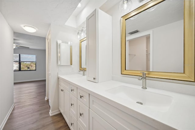 bathroom with vanity, wood-type flooring, and ceiling fan