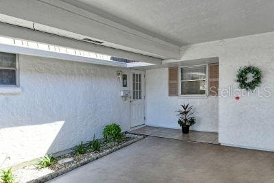 property entrance with a patio area