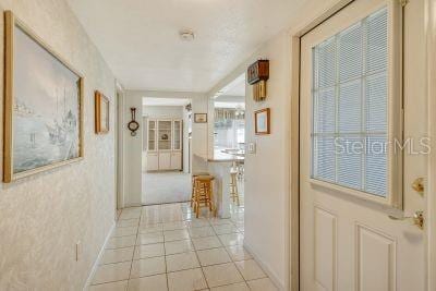 hall with light tile patterned floors