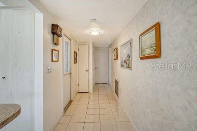 hall featuring light tile patterned floors