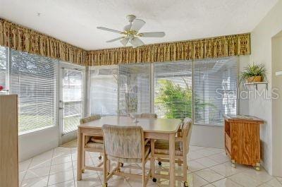 sunroom featuring plenty of natural light and ceiling fan