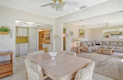 tiled dining space featuring ceiling fan