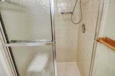 bathroom featuring a shower with shower door