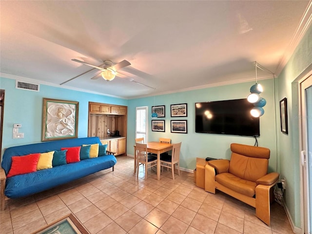 living area featuring light tile patterned floors, visible vents, ceiling fan, and ornamental molding