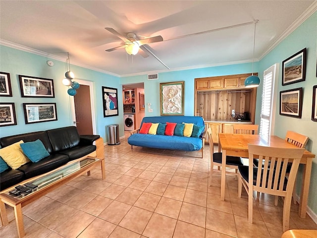 living area featuring washer / clothes dryer, light tile patterned flooring, visible vents, and ornamental molding