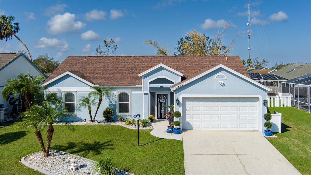 ranch-style house featuring a garage and a front lawn