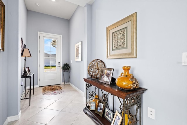 doorway to outside with light tile patterned flooring