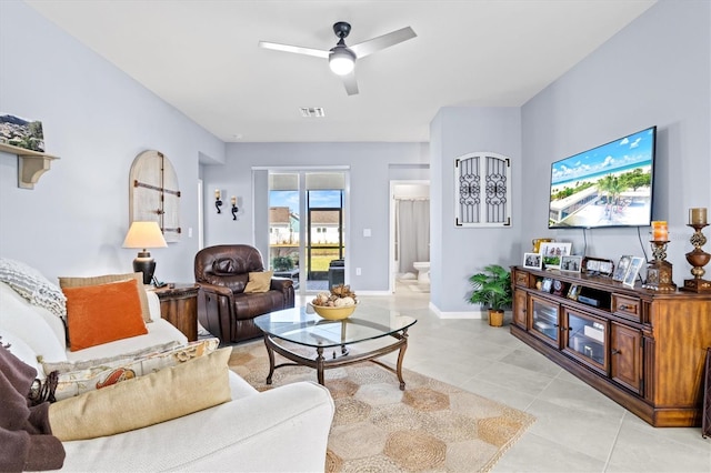 living room featuring ceiling fan and light tile patterned flooring