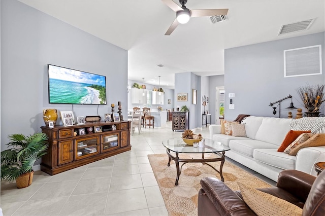 tiled living room with ceiling fan