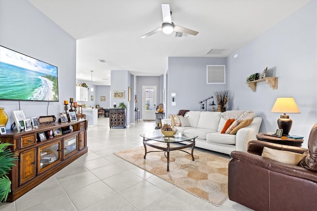 living room featuring light tile patterned floors and ceiling fan