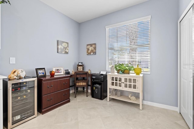 office area with light tile patterned flooring and beverage cooler