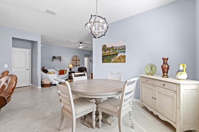 tiled dining room featuring ceiling fan with notable chandelier