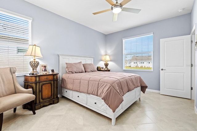 bedroom featuring multiple windows, light tile patterned floors, and ceiling fan