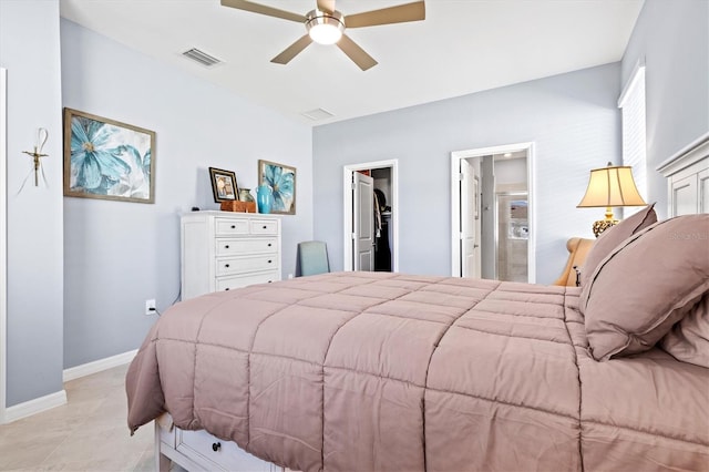 tiled bedroom featuring ensuite bathroom, a walk in closet, a closet, and ceiling fan