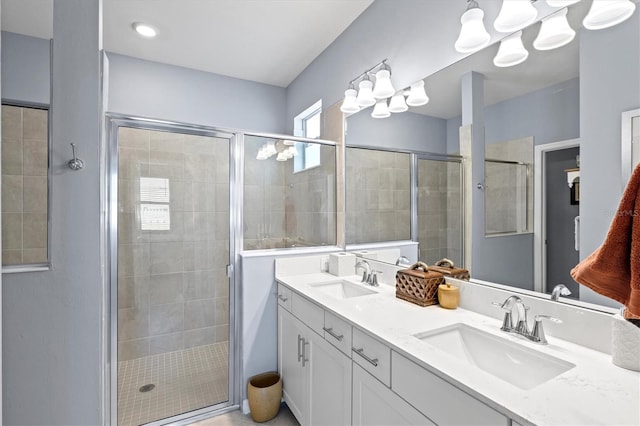 bathroom with vanity and a shower with shower door