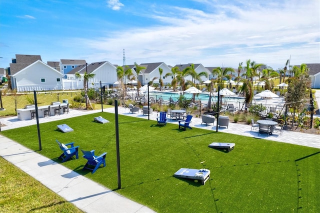 surrounding community featuring a patio area, a lawn, and a pool