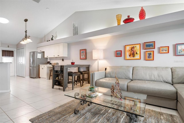 living room featuring high vaulted ceiling and light tile patterned floors