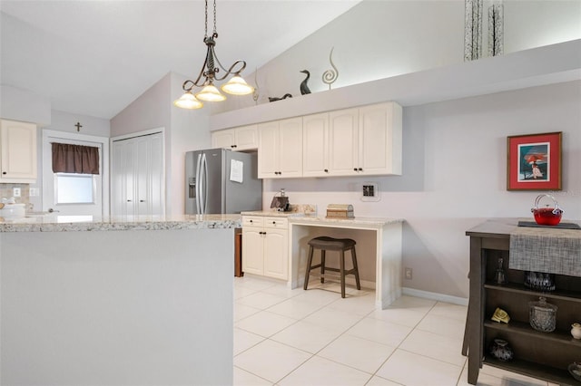 kitchen with kitchen peninsula, white cabinetry, vaulted ceiling, pendant lighting, and a breakfast bar area